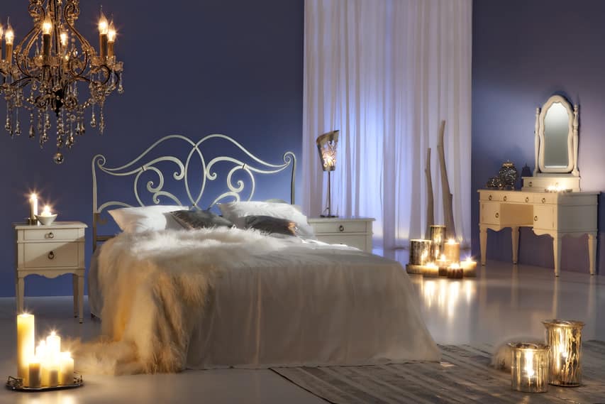 Romantic bedroom design with glass chandelier and candles