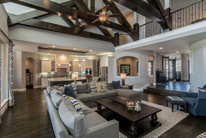 luxury living room with vaulted ceiling dark wood floors and open to kitchen