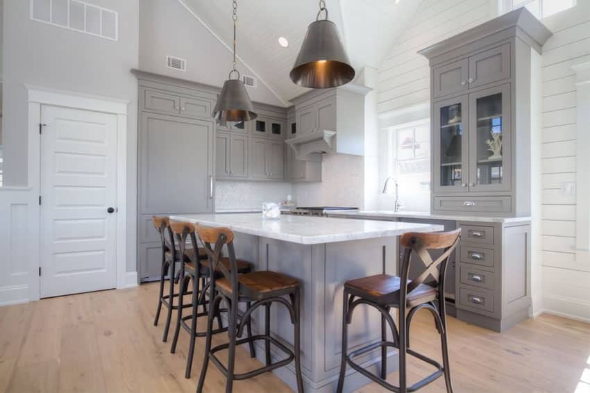 traditional-kitchen-with-gray-cabinets-white-marble-counter-and-metal-funnel-pendant-lights