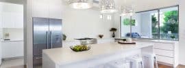 modern-white-cabinet-kitchen-with-island-with-simple-bar-stools-and-silver-drum-pendant-lights