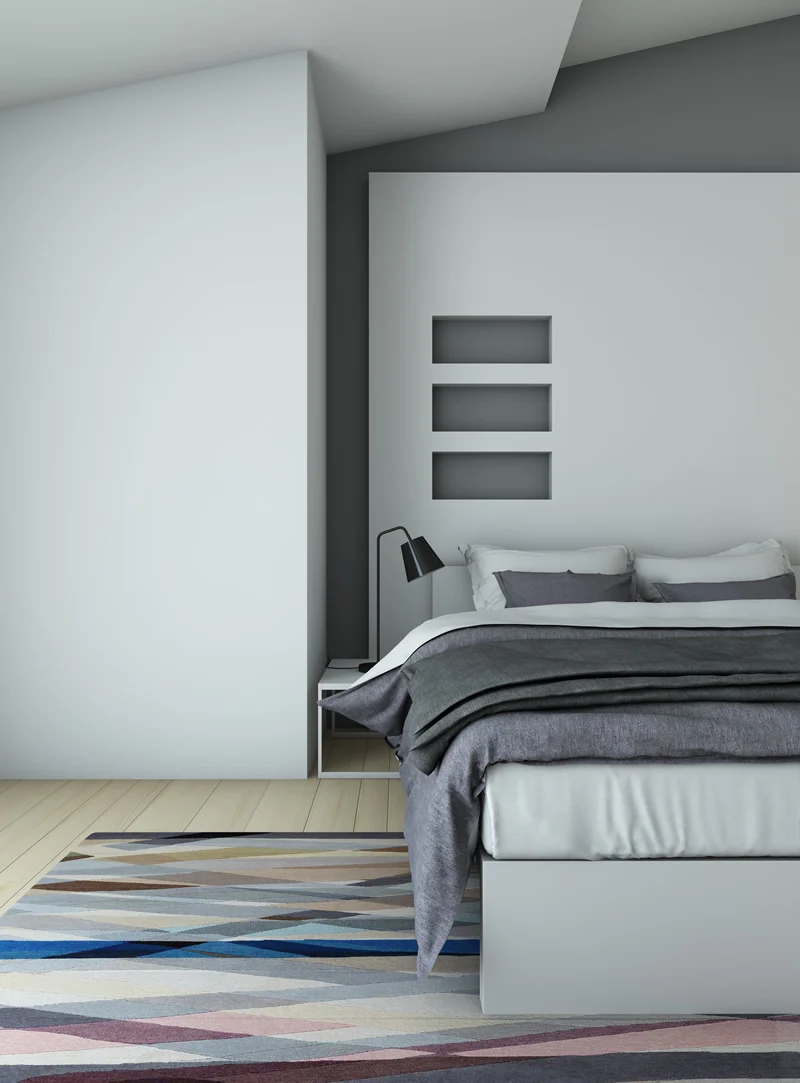 Grey colored bedroom with black table lamp