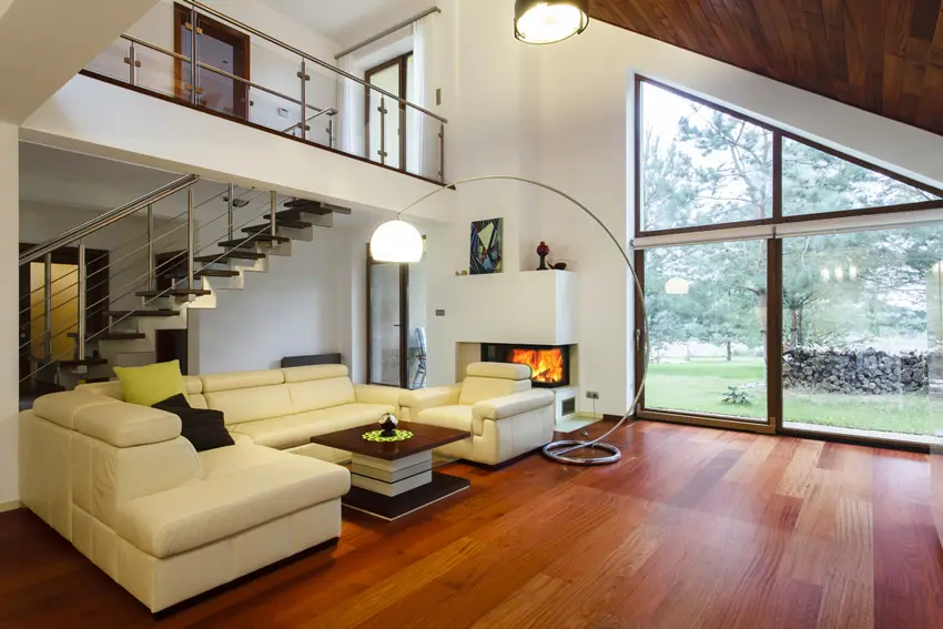 Designer house living space with wood flooring and garden view