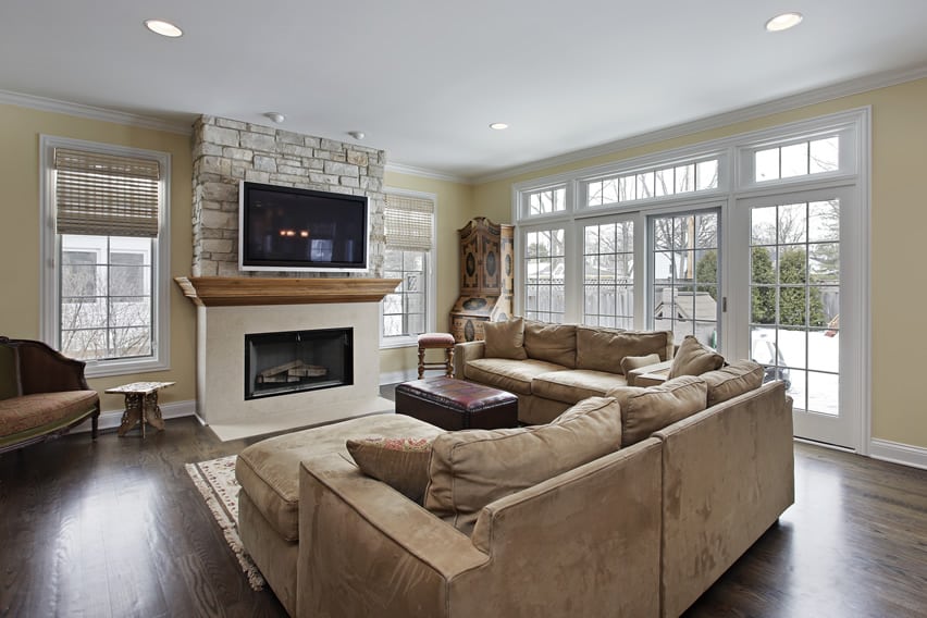 Family room with stone wall fireplace and hardwood floors