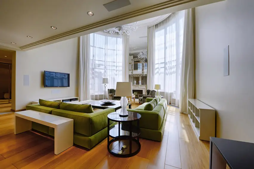Green couches and tan furniture