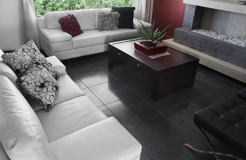 Living room with black tile and white furniture with an indoor fire pit