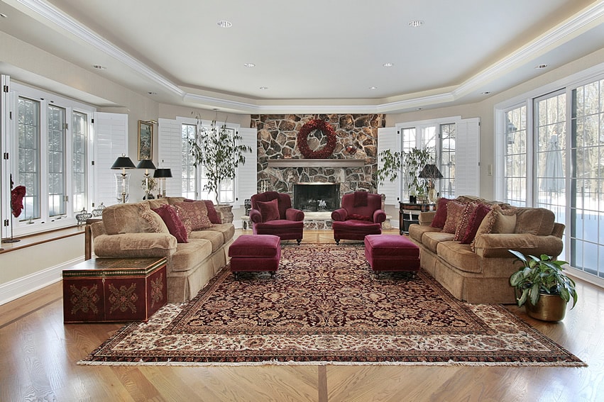 Luxury family room with large carpet and rock fireplace