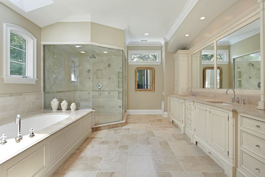Master bathroom with large glass shower dual sinks in white theme