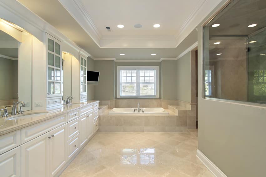 Bathroom with celadon walls, tray ceiling and panel window cabinets