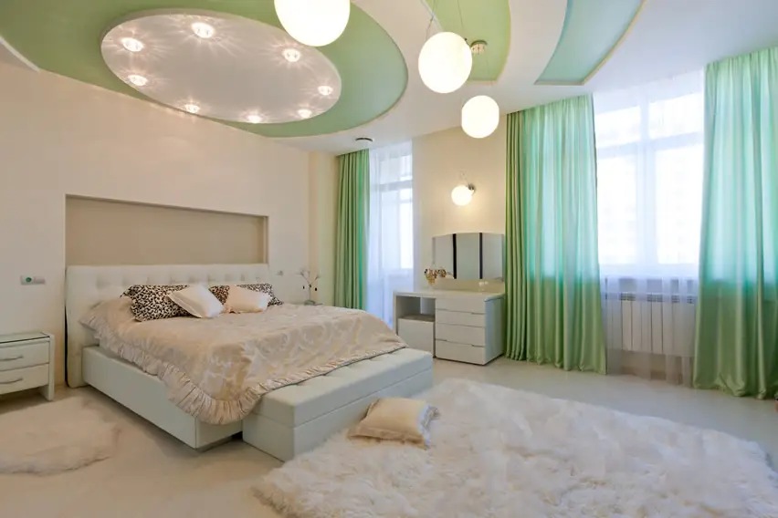 Room with mint green curtains, recessed wall and circles and curve detailing