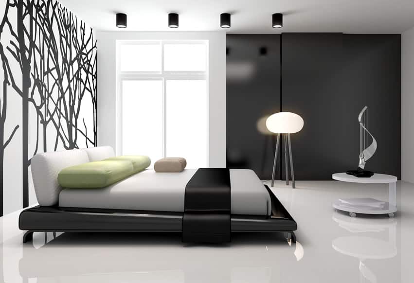 Bedroom with tree wall mural, yellow green pillows and floor lamp