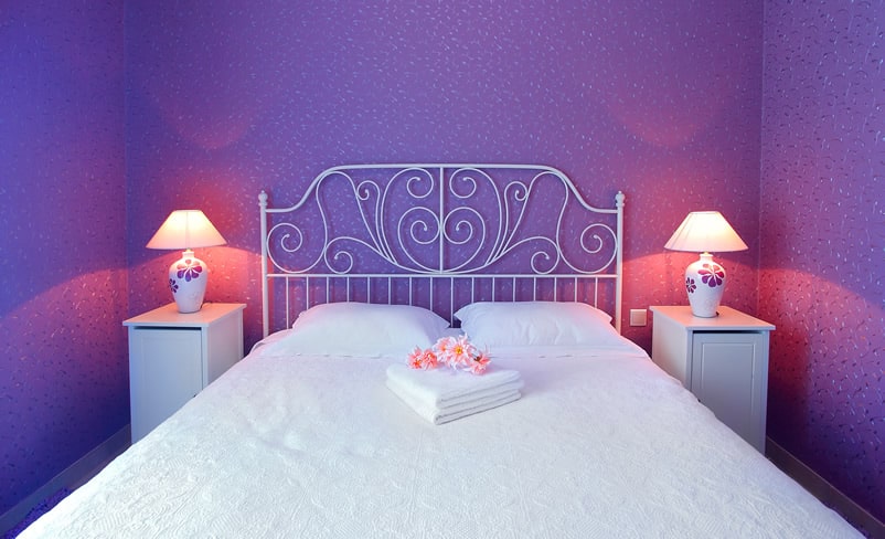 Pretty purple bedroom with decorative headboard