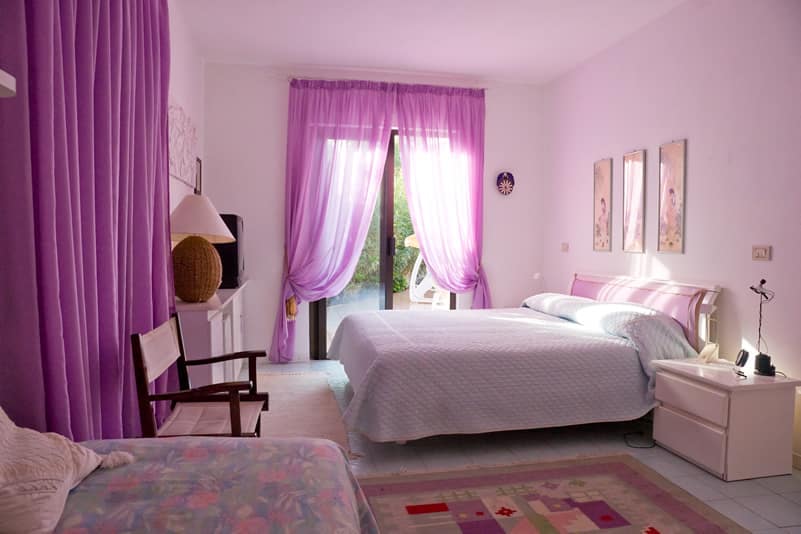 Purple color room with matching drapes rug
