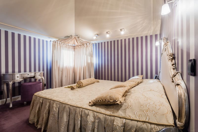 Regal purple bedroom striped wall elegant lighting