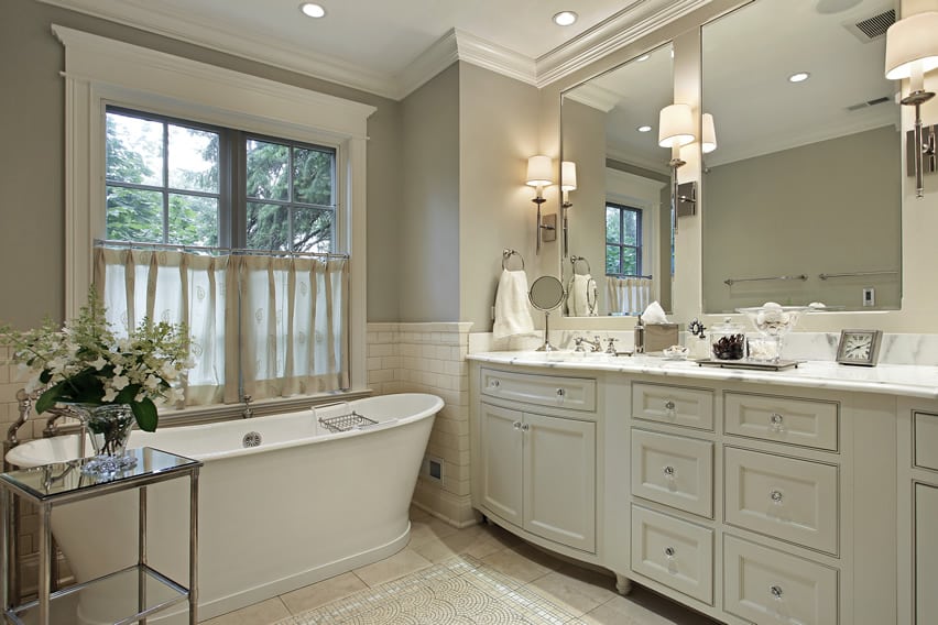 White bath with matching cabinets and marble counter
