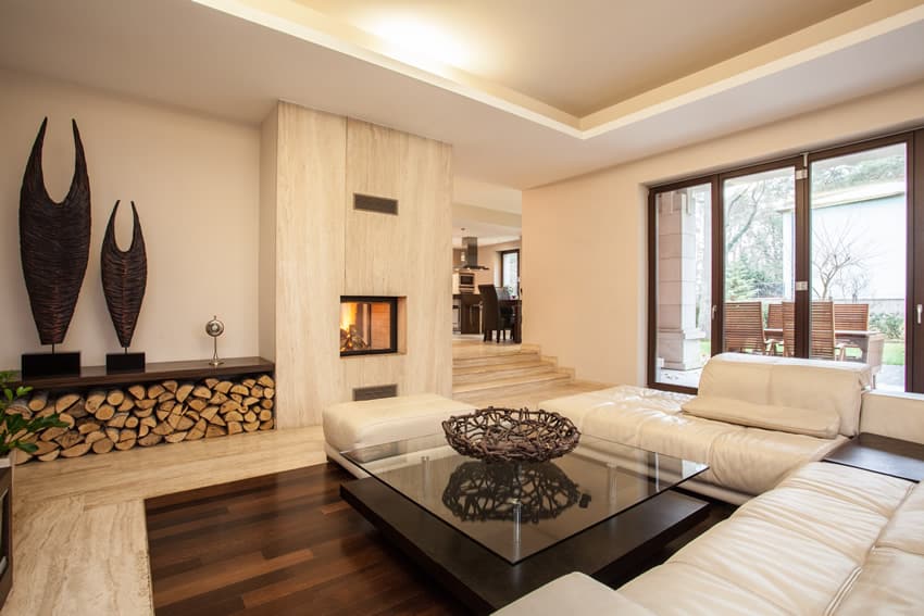 White living room with hardwood floor and wood fireplace