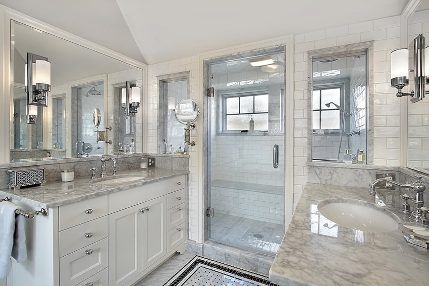 All-white classic bathroom with patterned tile flooring and chrome finish faucet