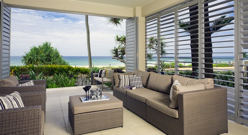 Oceanfront modern patio with sliding doors with horizontal shutters