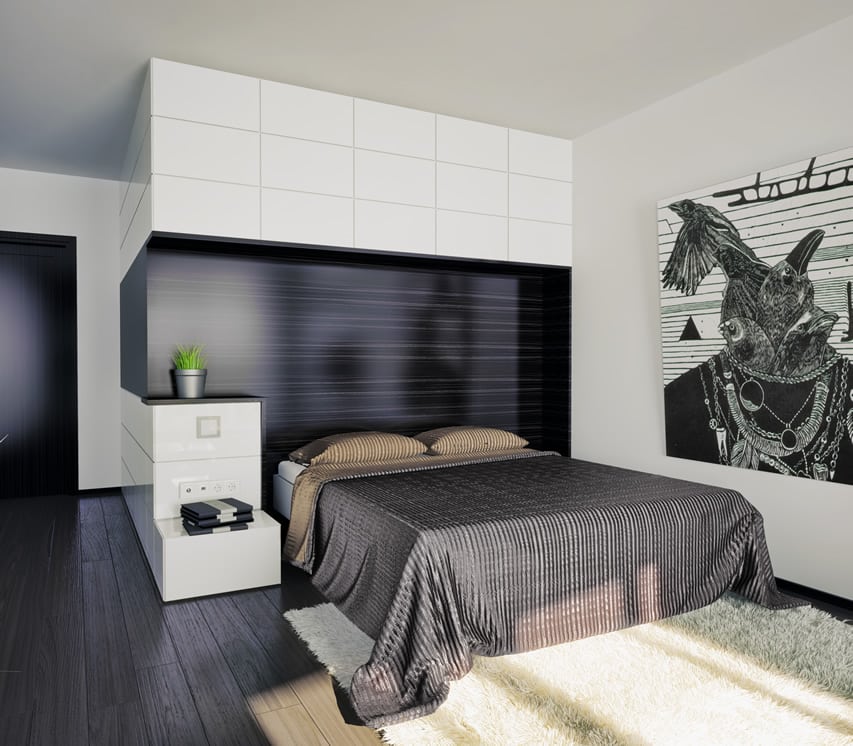 Modern bedroom with black headboard and wood floor panels and white walls