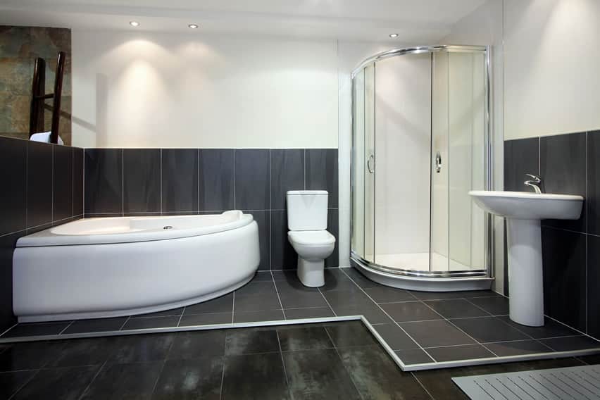 Bathroom with Italian ceramic tiles and corner bath area with glass enclosure