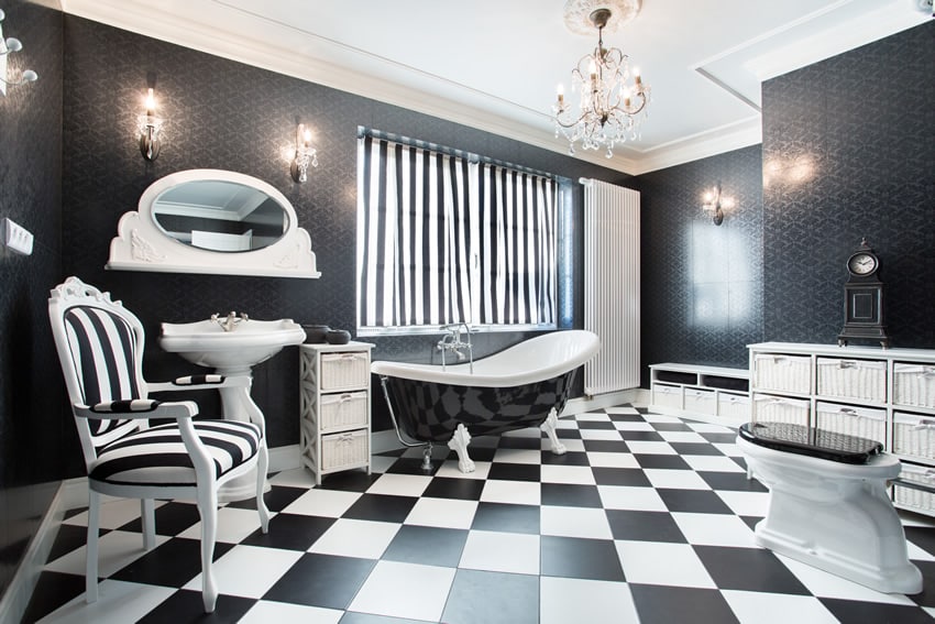 Bathroom with checkerboard flooring, black walls and chandelier