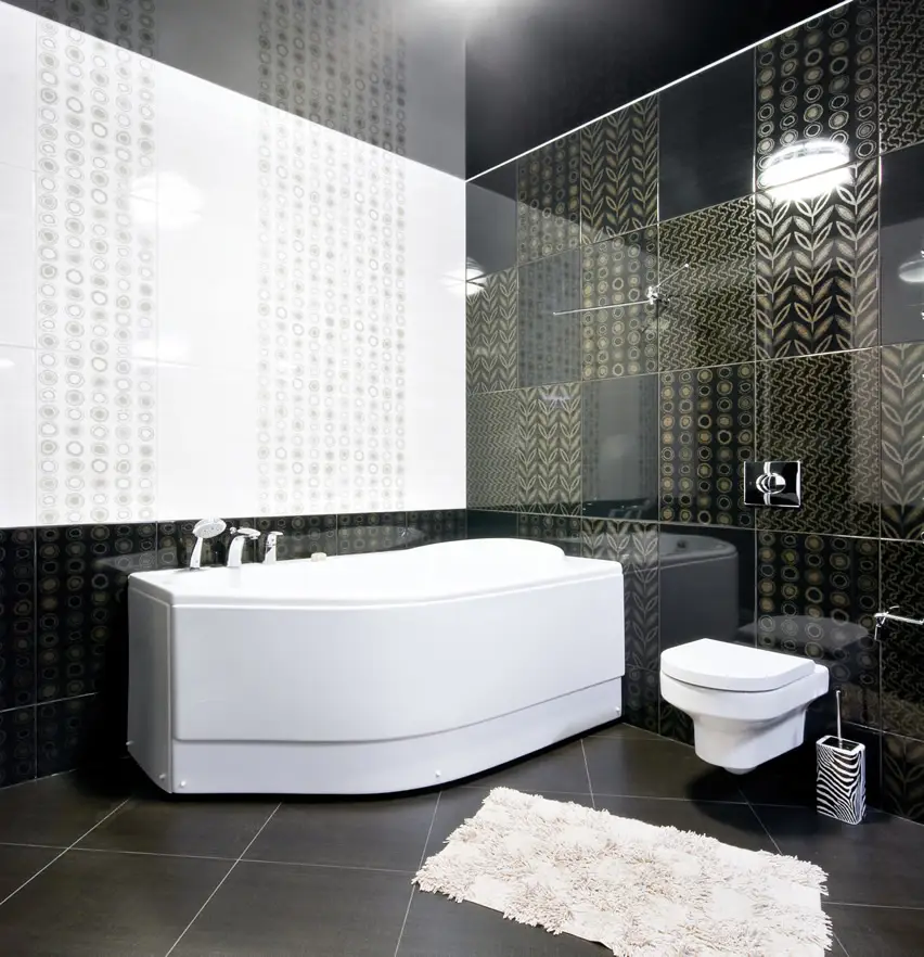 Bathroom with irregular shaped tub and wall tiles with gold inlay