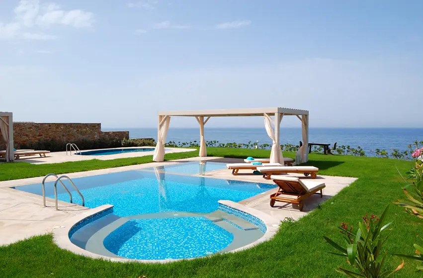 Clear pool with curtained cabana 