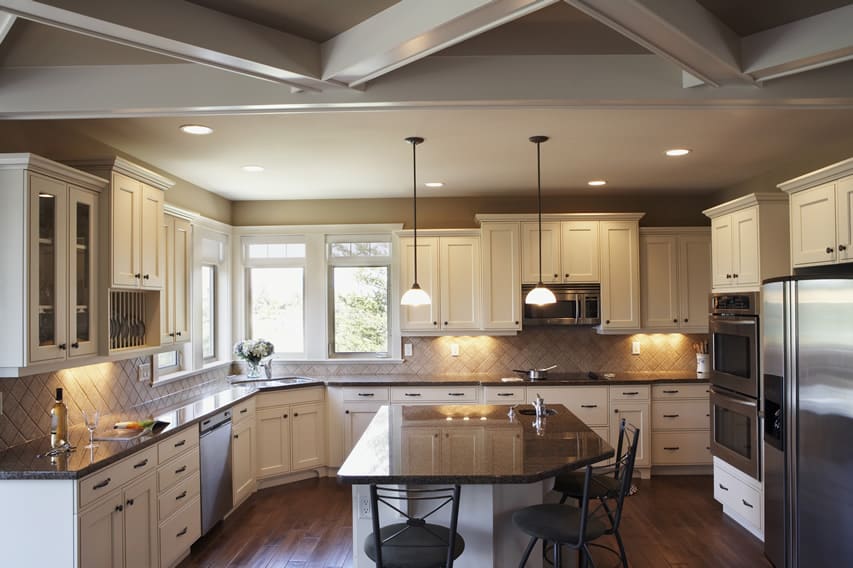 Kitchen with diagonal beam feature on the ceiling and irregular shaped counter