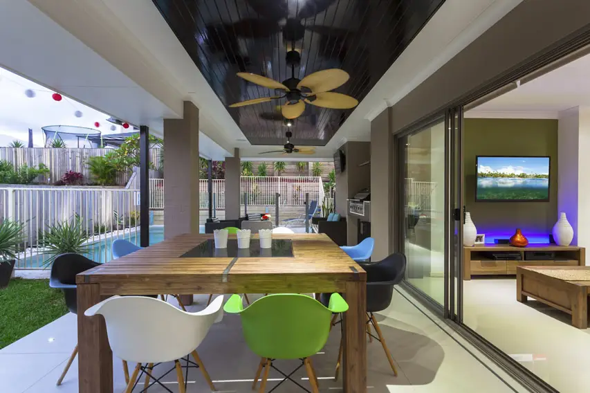 Patio with ceiling fan and large glass sliding door to living space