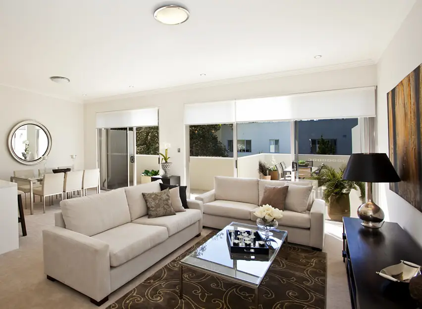 Cozy space with white couches and brown rug