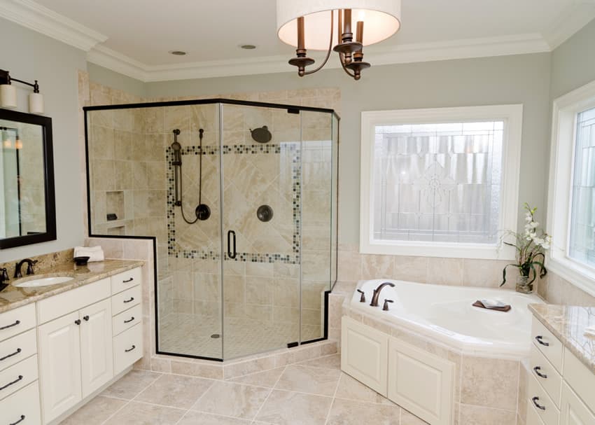 Bathroom with glazed tiles, corner ceramic tub and drum chandelier
