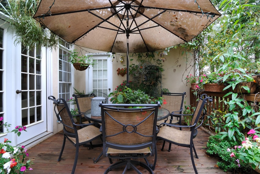 Garden patio area with weathered wood floor planks and umbrella