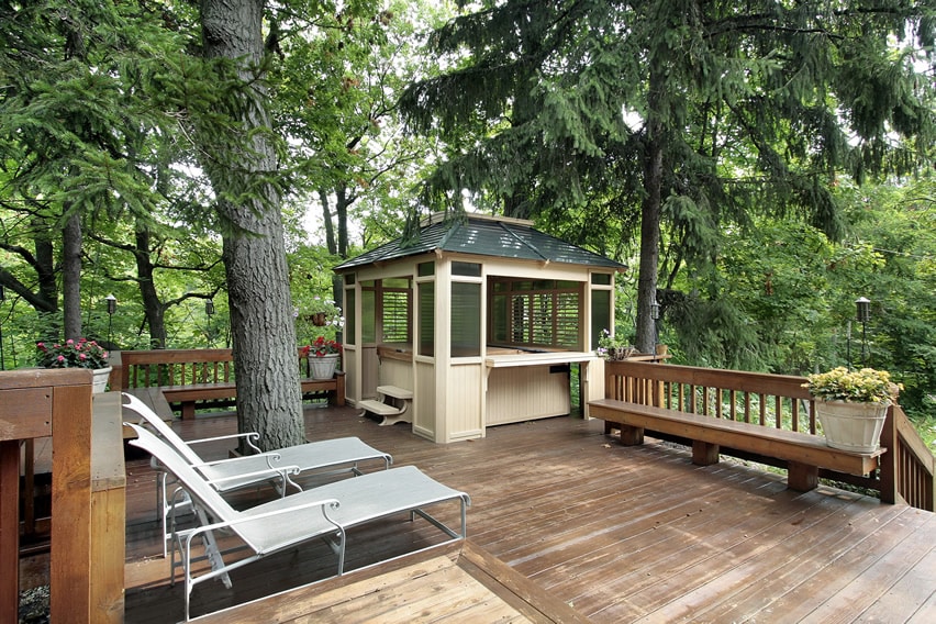 Deck with tree view a gazebo and hot tub area