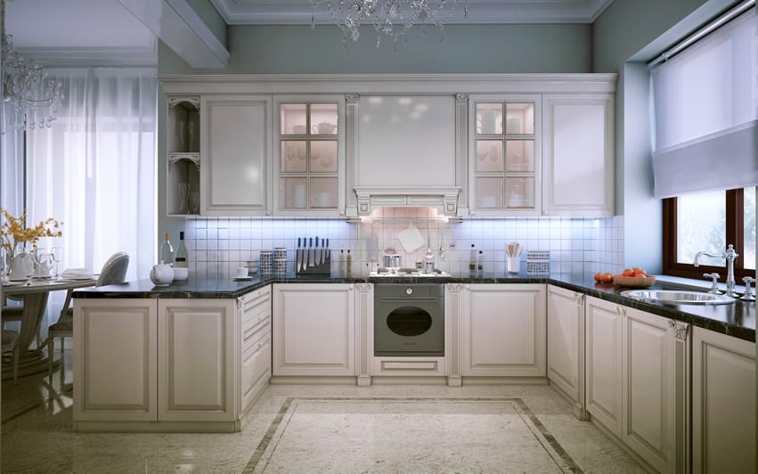 J-shaped kitchen with mint green walls, frosted glass cabinets and brown border tiles