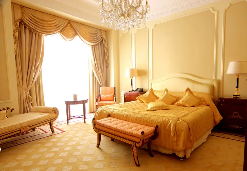 Elegant master bedroom with large crystal chandelier
