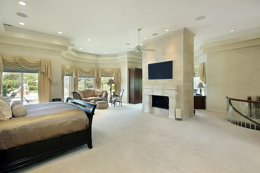 Expansive master bedroom with fireplace and wardrobe