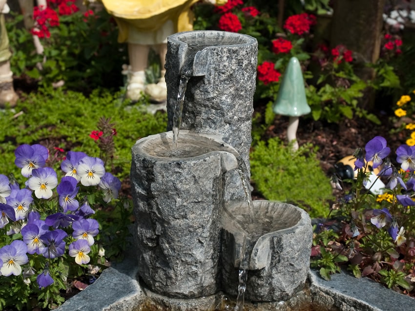 Garden flowers and granite fountain