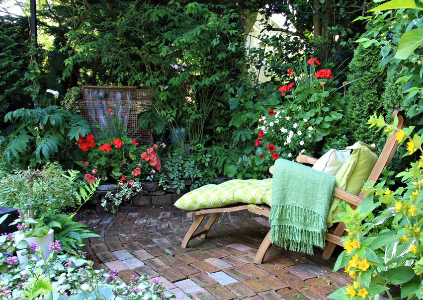 Garden lounge chair near water flow feature
