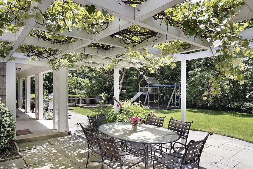 Beautiful patio with white pergola and outdoor dining area