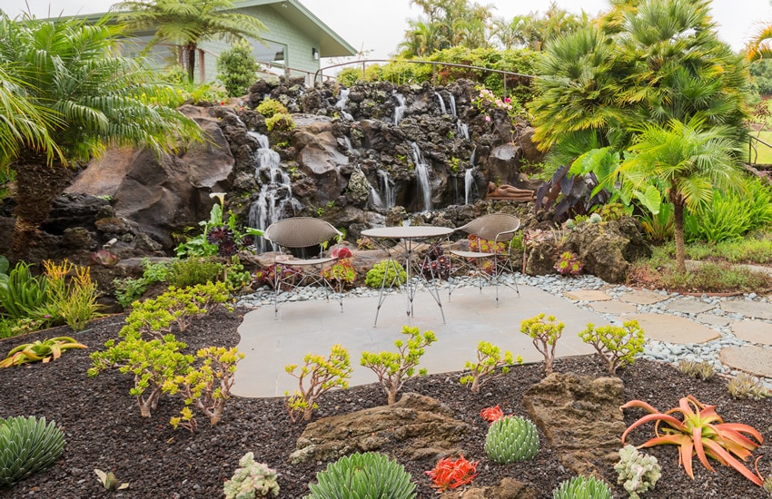 Garden patio with rock flowing waterfall