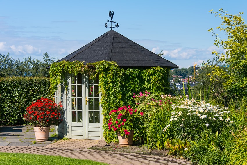 glass door gazebo in flower garden