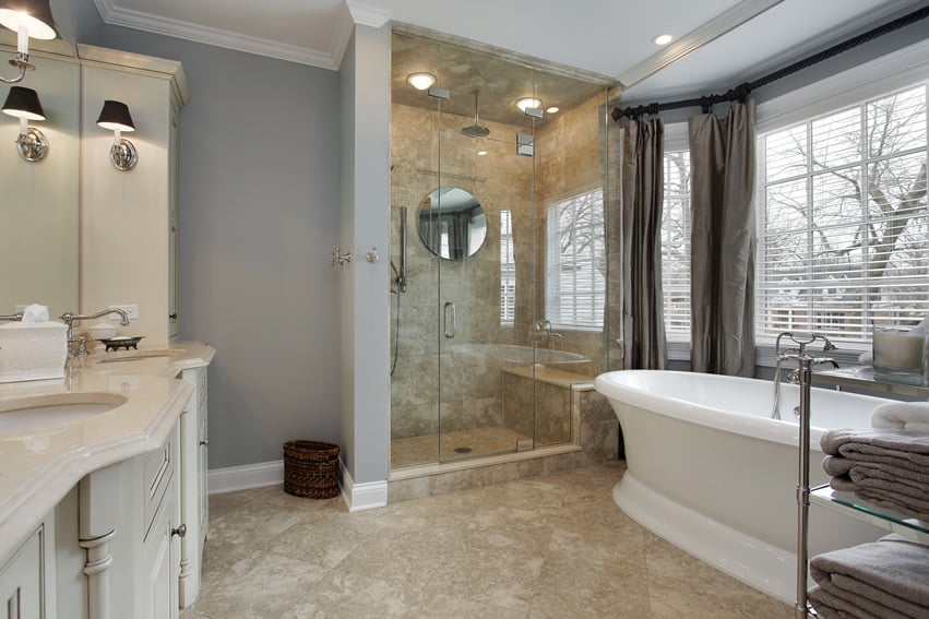 Bathroom combines warm colors and is painted in a cool shade of gray with white moldings