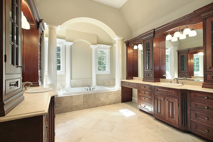 Beautiful bathroom uses non-slip porcelain tiles with light tan paint for the walls and a similar-colored cream granite countertop