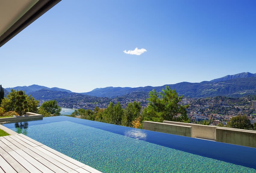 Infinity pool with view of town and mountains