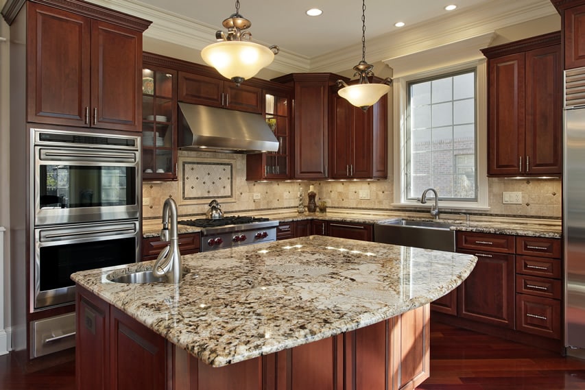 Kitchen with polished Giallo St. Cecilia granite and engineered floors