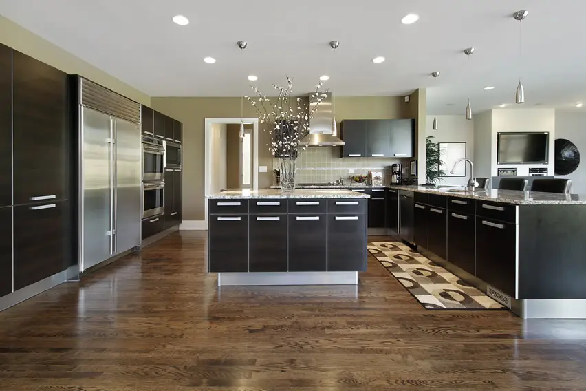 Kitchen with tongue and groove floors and laminated ebony cabinets
