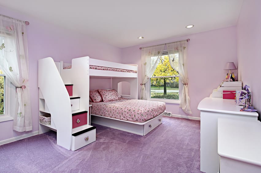 Purple room with bed with secret storage areas, carpeted floors and windows with curtains