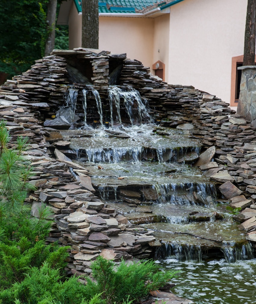 Large slate waterfall flowing in garden