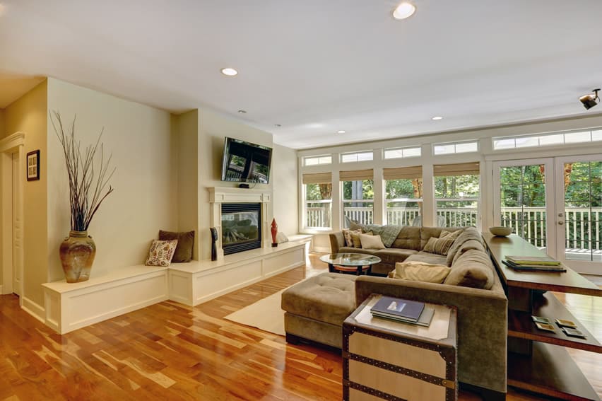 Living room in luxury home with fireplace and hardwood flooring