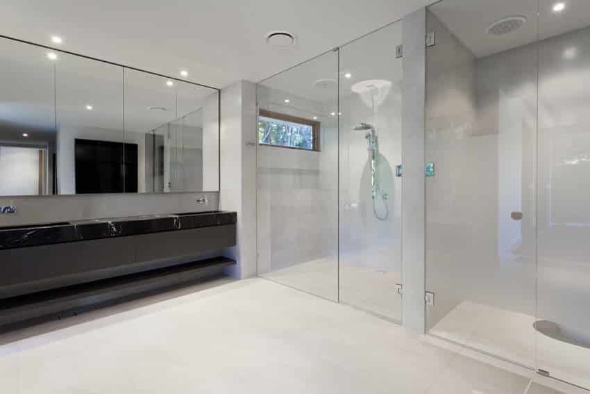 Bathroom with glass walls and black countertops