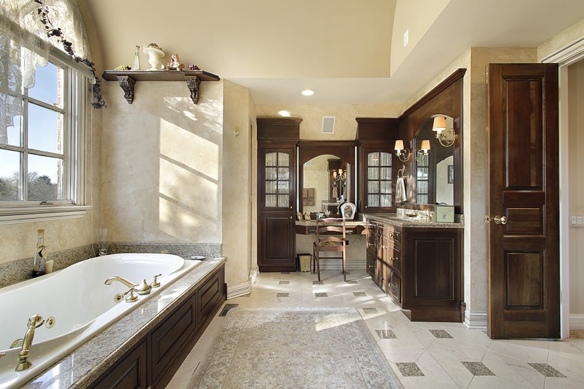 Cozy bathroom design with classical design elements using marble porcelain tiles with smaller pieces of granite tiles
